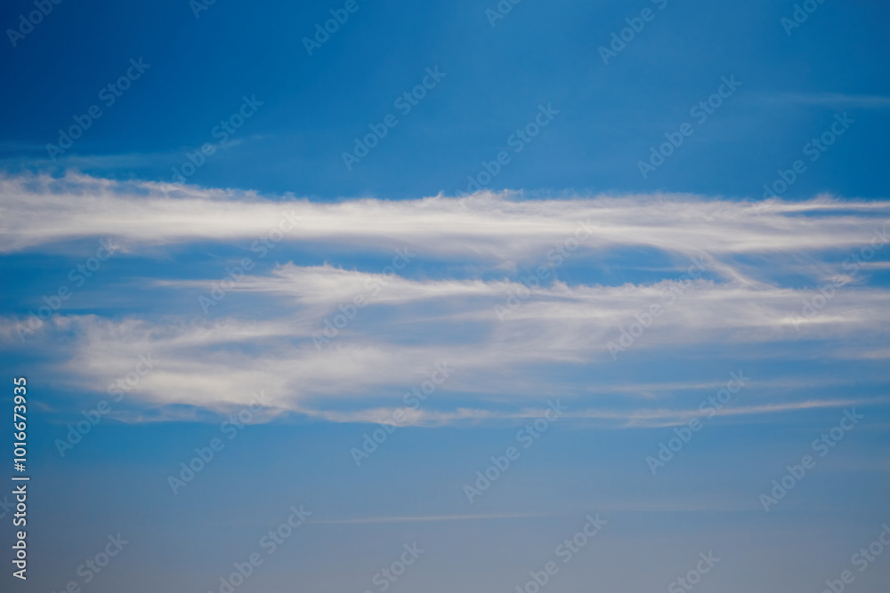 Thin stripes of white clouds in a blue sky, close-up Thin stripes of white clouds in a blue sky, close-up