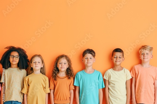 Group of kids standing together and looking at camera isolated on orange background