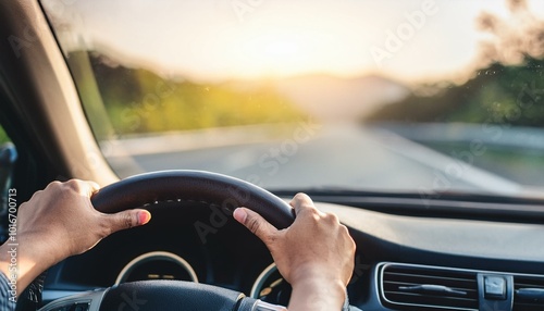 hands of car driver on steering wheel