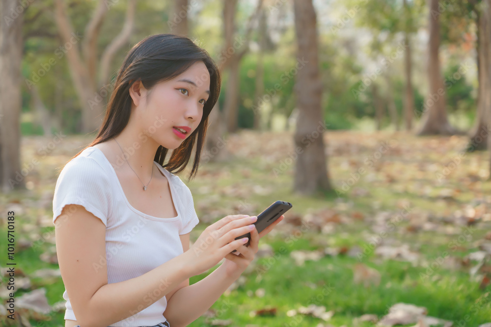 Young asian women sitting on bicycle to reading message chat and checking social media on smartphone after cycling bicycle in the park while relaxation with journey travel lifestyle for healthy Young asian women sitting on bicycle to reading message chat and checking social media on smartphone after cycling bicycle in the park while relaxation with journey travel lifestyle for healthy