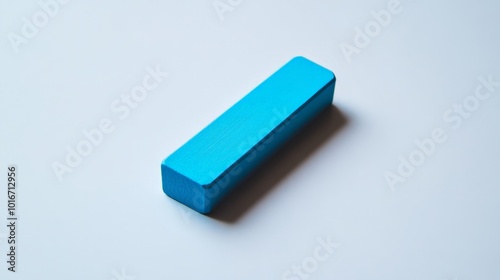 A bright blue rectangular eraser on a clean white background, showcasing simplicity and minimalism in design and stationery.