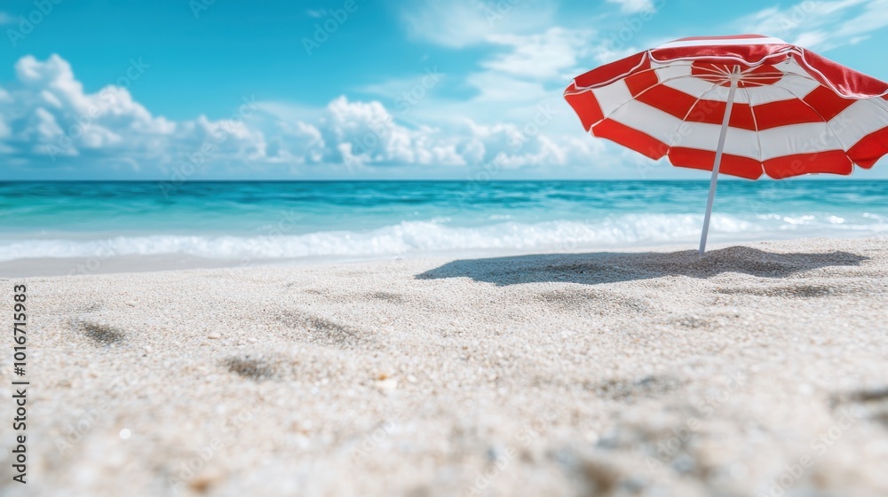 A vibrant red beach umbrella provides shade on a sandy beach, set against a clear blue sky and calm ocean waves, inviting relaxation and enjoyment of nature. A vibrant red beach umbrella provides shade on a sandy beach, set against a clear blue sky and calm ocean waves, inviting relaxation and enjoyment of nature.
