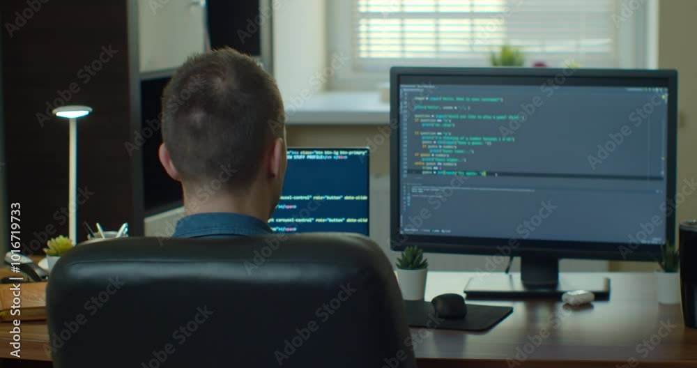 Young man freelancer coding html and programming on two screen Monitors, development web, developer.