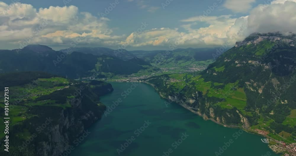Water transport in Switzerland. Navigating a Swiss Lake. Aerial view steamboat ship on lake Interlaken. Switzerland summer tourism destination. Turquoise blue water. Swiss flag on a passenger ship Water transport in Switzerland. Navigating a Swiss Lake. Aerial view steamboat ship on lake Interlaken. Switzerland summer tourism destination. Turquoise blue water. Swiss flag on a passenger ship