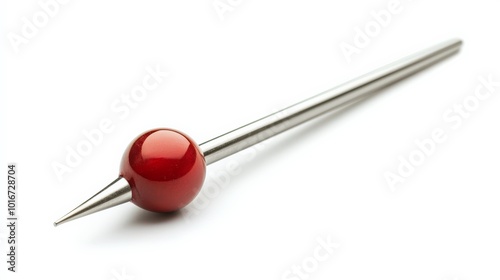 Close-up of a sleek red pin with a shiny spherical head and a sharp metallic shaft, isolated against a white background.