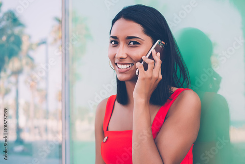 Close up portrait if cheerful Hispanic woman communicating via new smartphone application and enjoying high speed roaming connection, happy gladden woman received good news during cell talking