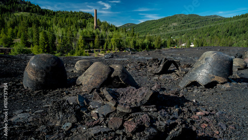 Canvas Print Forlorn and abandoned, all that remains of the once mighty Anaconda Copper Mine's smelter is a gargantuan heap of slag and a solitary smoke stack