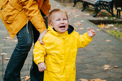 Crying little boy outdoor in the park.
