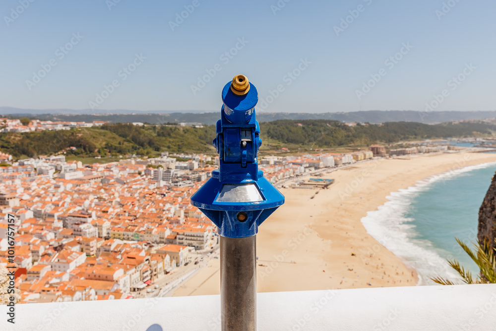 Blue telescope overlooking the bay of Nazare, Portugal