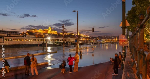 Budapest, Hungary - September 18, 2024: Flooded Jane Haining highway. Buda castle on the background. Evening to night transition. Time lapse, zoom out transition. photo