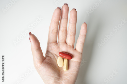 Hand Holding Colorful Pills for Health and Wellness Concept