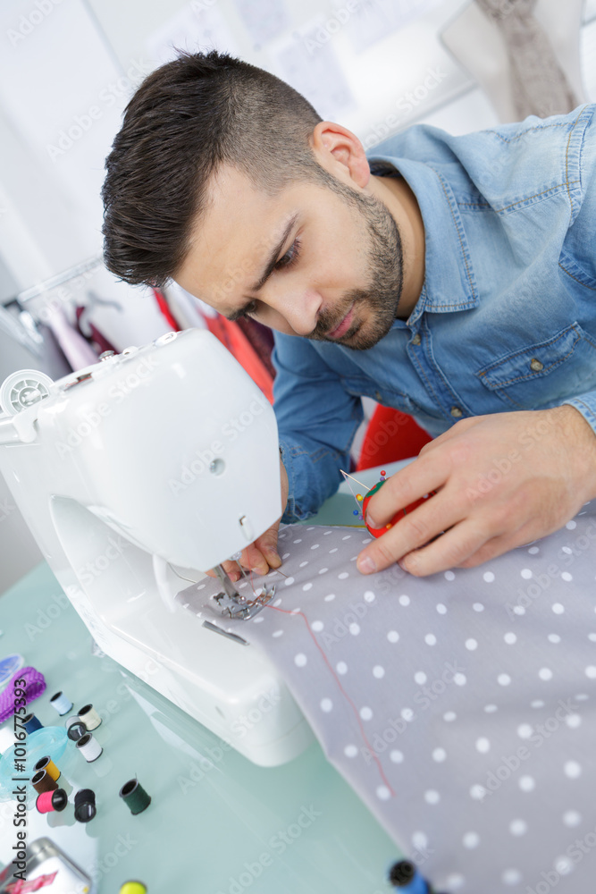 handsome young man working as a tailor handsome young man working as a tailor