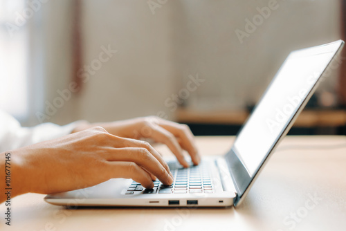 Businessman hand typing on computer keyboard of a laptop computer in office. Business and finance concept. uds