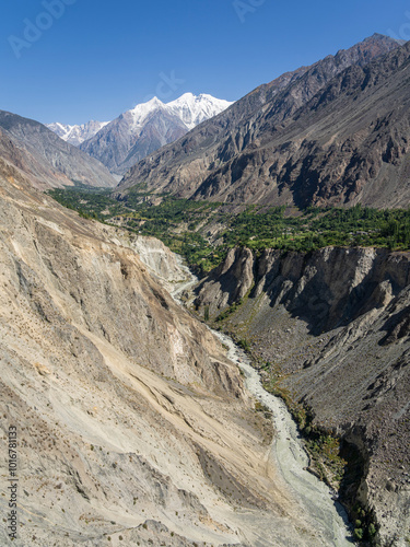 Vertical landscape view of Bagrot valley with snow-capped Diran peak in background, Gilgit, Gilgit-Baltistan, Pakistan photo