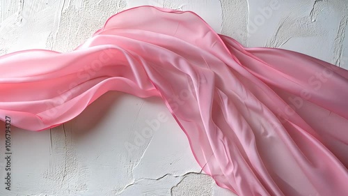Pink silk fabric flowing on white background