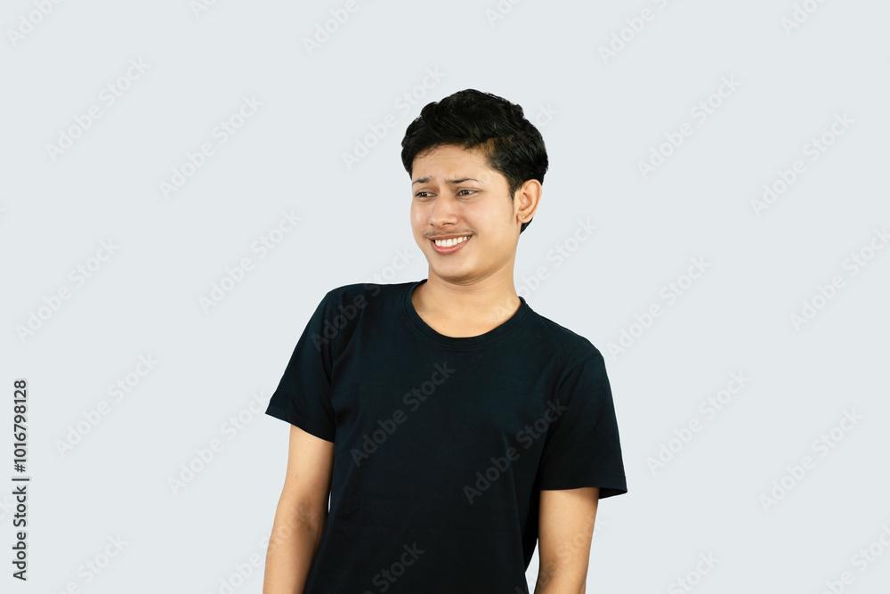 Young Asian Male boy with Black Tshirt points with finder gives expression and gestures of happy wow sad surprise Young Asian Male boy with Black Tshirt points with finder gives expression and gestures of happy wow sad surprise