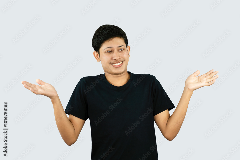 Young Asian Male boy with Black Tshirt points with finder gives expression and gestures of happy wow sad surprise Young Asian Male boy with Black Tshirt points with finder gives expression and gestures of happy wow sad surprise