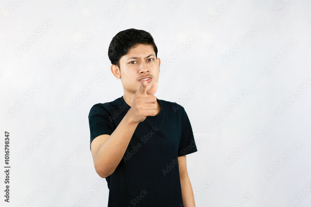 Young Asian Male boy with Black Tshirt points with finder gives expression and gestures of happy wow sad surprise Young Asian Male boy with Black Tshirt points with finder gives expression and gestures of happy wow sad surprise