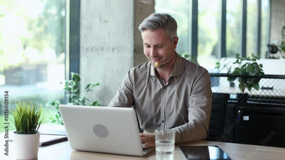 Happy young male customer support executive working in office. Happy young male customer support executive working in office.