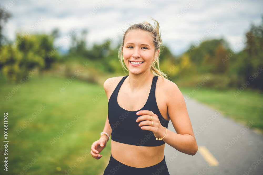 Front view of a happy runner teen doing jogging Front view of a happy runner teen doing jogging