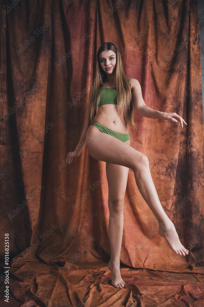 Naklejka premium Photo no retouch of happy carefree stunning lady wearing lingerie dancing in studio over brown color background