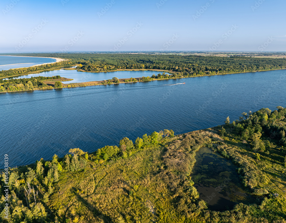 Fototapeta premium The Vistula river and two small lakes in the rays of the setting sun, the mouth of the Vistula, northern Poland