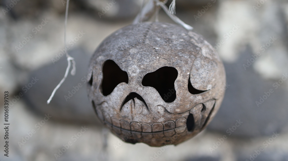 Coconut Shell Sculpture Skull hanging on a Rope for Halloween Coconut Shell Sculpture Skull hanging on a Rope for Halloween
