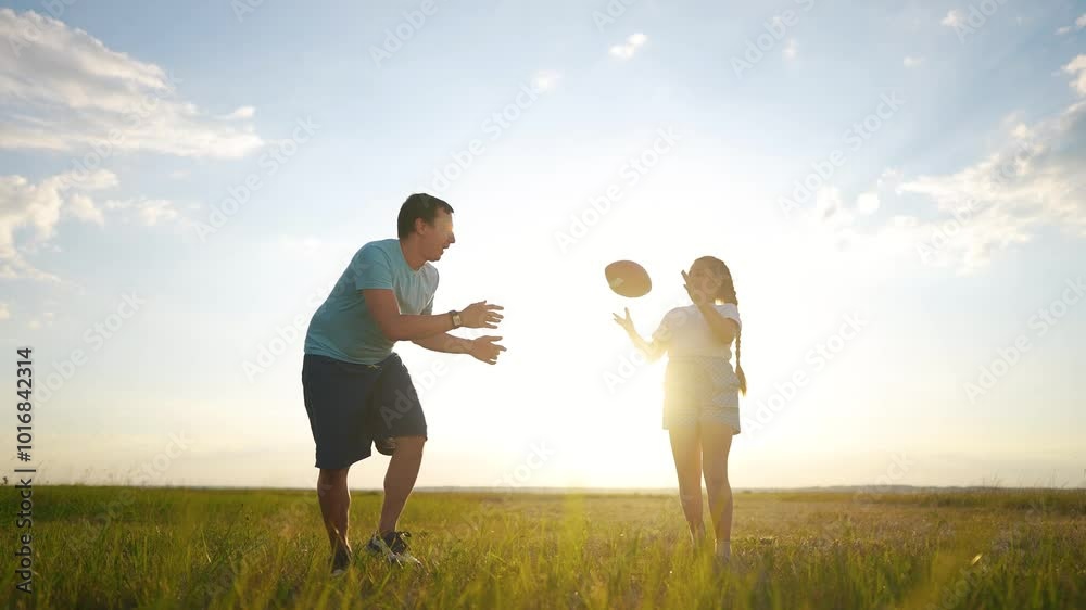 A father teaches his son to play football. Soccer child parent family concept. Father and son playing football with fun ball. Father teaches his son to play. football. family happy childhood concept. A father teaches his son to play football. Soccer child parent family concept. Father and son playing football with fun ball. Father teaches his son to play. football. family happy childhood concept.