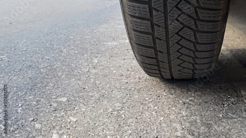 Wallpaper Mural Close-up of a car tire on an asphalt road, illustrating vehicle safety and the importance of regular maintenance Torontodigital.ca