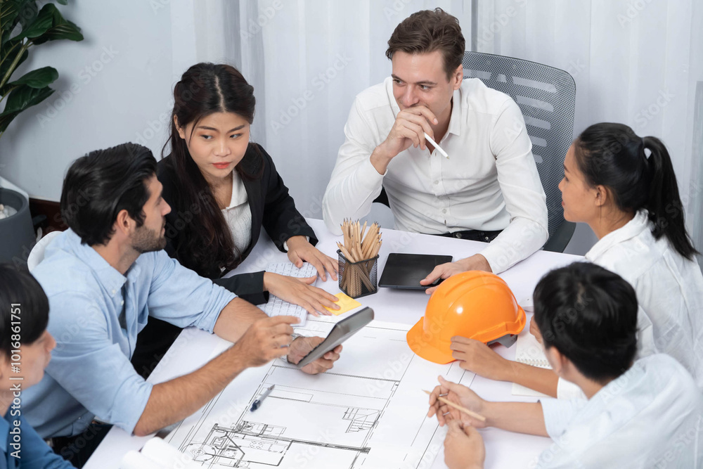 Diverse group of civil engineer and client working together on architectural project, reviewing construction plan and building blueprint at meeting table. Prudent Diverse group of civil engineer and client working together on architectural project, reviewing construction plan and building blueprint at meeting table. Prudent
