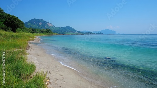 Tranquil shoreline with shimmering waters and distant mountains at a sunny coastal retreat