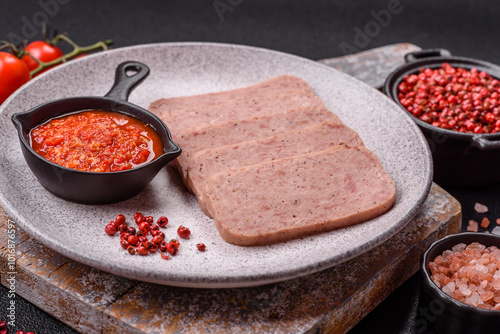 Delicious canned pink spiced ham or spam with salt, spices and herbs photo