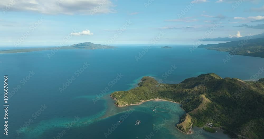 Blue sea and tropical island with turquoise water atoll. Blue sky and clouds. Mati, Davao Oriental. Philippines. Blue sea and tropical island with turquoise water atoll. Blue sky and clouds. Mati, Davao Oriental. Philippines.