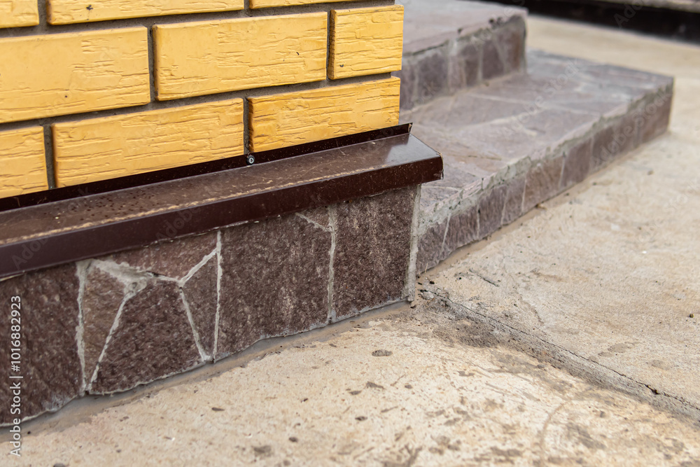The basement of the house is lined with stone. Facing the porch with stone The basement of the house is lined with stone. Facing the porch with stone