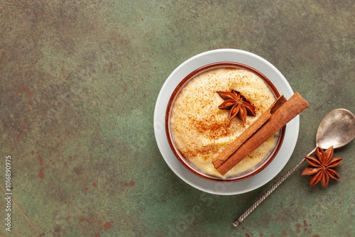 Curau de Milho (Brazilian Corn Pudding). Traditional Brazilian dessert. Corn porridge with cinnamon in a bowl. Top view