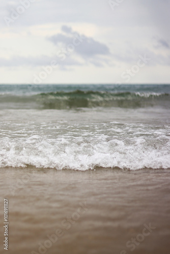 Sea view with small waves in cloudy weather. Balearic Sea, Salou, Spain. View of the waves on the sea from a lower angle. Landscape with sea and clouds