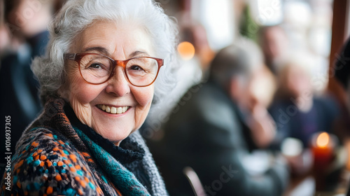 Elderly woman smiling warmly, surrounded by friends at a gathering