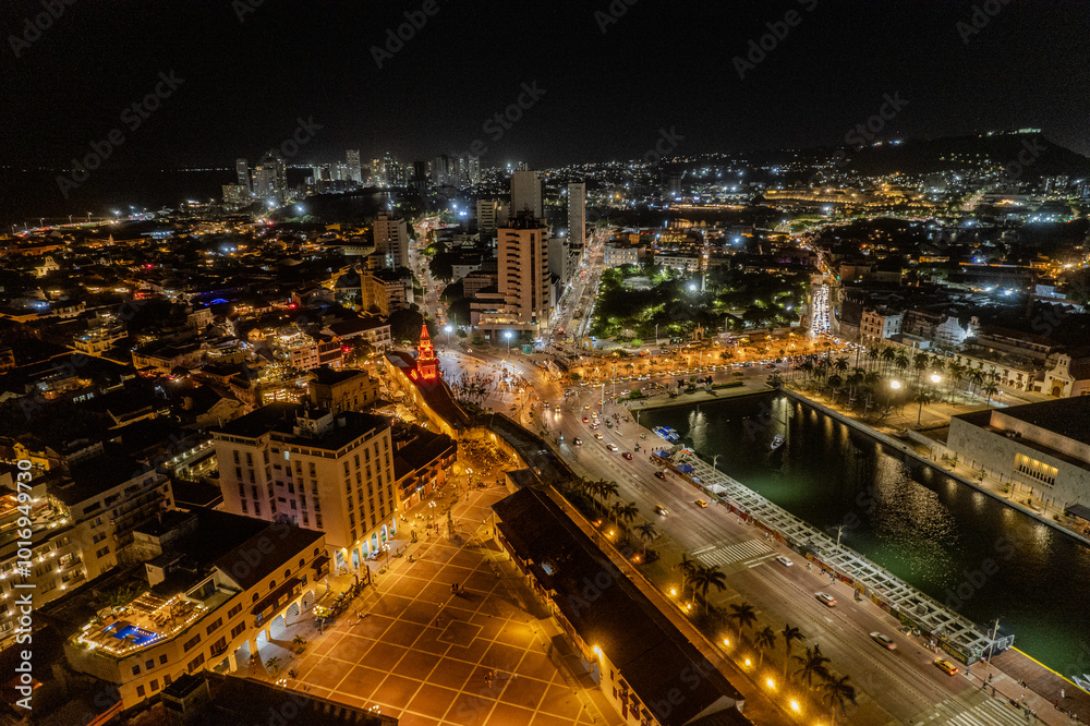 Fototapeta premium Beautiful Aerial view of the walled city of Cartagena de Indias in Colombia. Its Clock Tower entrance, the plaza, the sanctuary and the Domus Dei at night