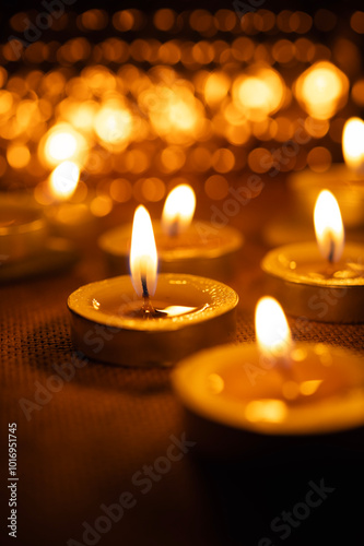 All Saints' Day greeting banner with bokeh effect. All Hallows' Day. Solemnity of All Saints. Candles with fire on shiny background