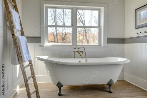 This stylish bathroom features a classic white clawfoot tub and minimalist decor. Large windows let in natural light, creating a serene space ideal for relaxation after a long day photo