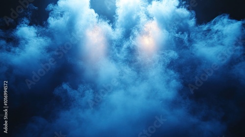 A dense blue smoke fills the air, gently illuminated by soft lights creating an ethereal atmosphere in an indoor space at night, enhancing the performanceвЂ™s dramatic effect