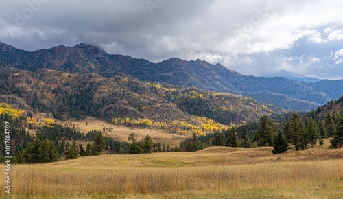 Serene autumn landscape showcasing vibrant foliage and majestic mountains in afternoon light