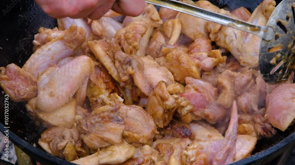 Chicken meat is stewed in a cauldron. A dish on a fire in a cauldron. The meat is stewed in a cauldron. Stewing meat in a cauldron Chicken meat is stewed in a cauldron. A dish on a fire in a cauldron. The meat is stewed in a cauldron. Stewing meat in a cauldron