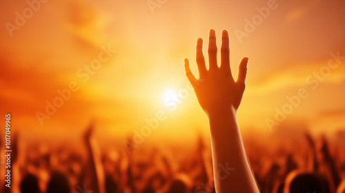 Crowd enjoying live concert at sunset, vibrant atmosphere, hands raised in excitement, music festival, joyful celebration, warm orange sky, outdoor entertainment event, summer vibes photo