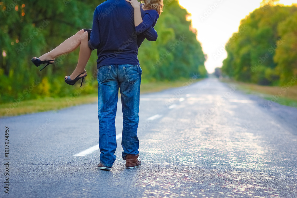 A Happy couple in love on the road in the park on nature travel A Happy couple in love on the road in the park on nature travel