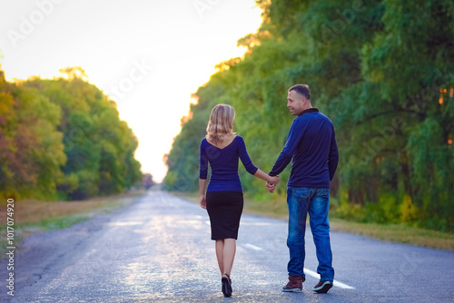 A Happy couple in love on the road in the park on nature travel