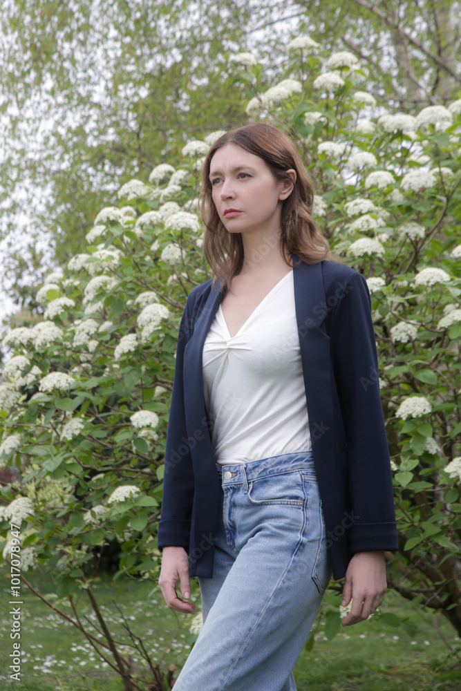 Outdoor portrait of young woman in navy blue casual blazer, denim trousers and basic white cotton shirt Outdoor portrait of young woman in navy blue casual blazer, denim trousers and basic white cotton shirt