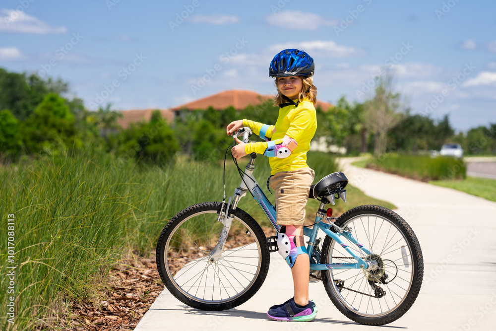 Little kid boy ride a bicycle in the park. Kid cycling on bicycle. Happy smiling child in helmet riding a bike. Boy start to ride a bicycle. Sporty kid bike riding on bikeway. Kids bicycle. Little kid boy ride a bicycle in the park. Kid cycling on bicycle. Happy smiling child in helmet riding a bike. Boy start to ride a bicycle. Sporty kid bike riding on bikeway. Kids bicycle.