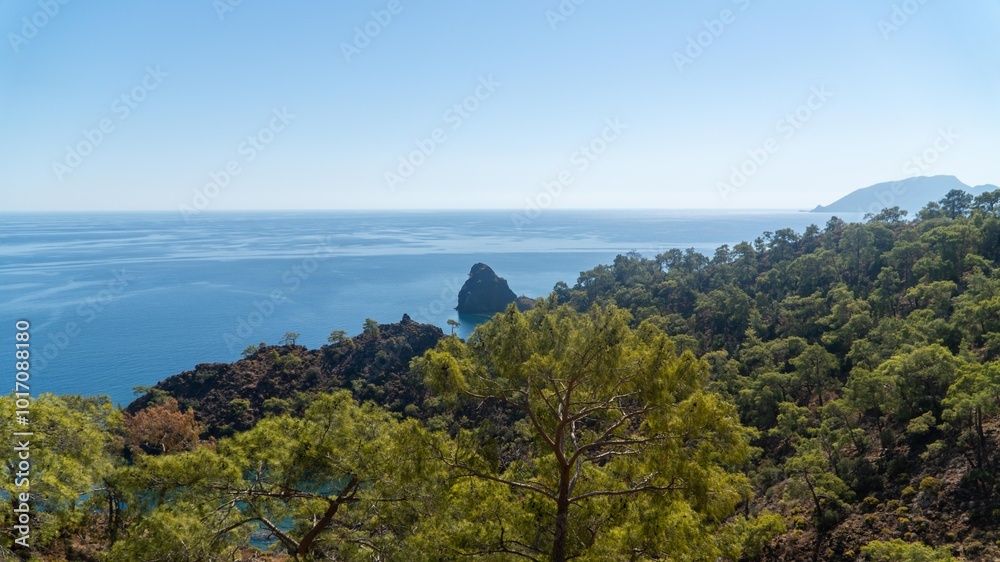 Turkish Mediterranean coastline as seen from the Lycian Way in Antalya, Turkey with a blue sea, lush green forests, and rugged rocky shores, attracting tourists every summer. Turkish Mediterranean coastline as seen from the Lycian Way in Antalya, Turkey with a blue sea, lush green forests, and rugged rocky shores, attracting tourists every summer.