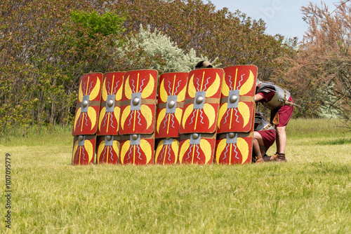 Roman legionaries in testudo formation with red shields